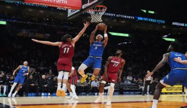 Orlando Magic forward Paolo Banchero (5) drives to the basket as Miami Heat forward Jaime Jaquez Jr. (11) defends during the first half of an NBA basketball game Wednesday, Jan. 28, 2026, in Miami. (AP Photo/Marta Lavandier)