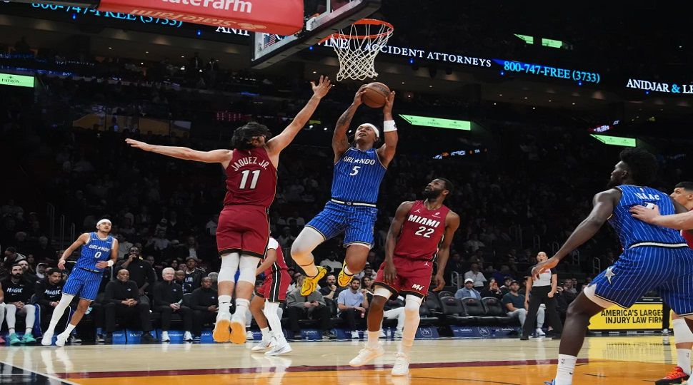 Orlando Magic forward Paolo Banchero (5) drives to the basket as Miami Heat forward Jaime Jaquez Jr. (11) defends during the first half of an NBA basketball game Wednesday, Jan. 28, 2026, in Miami. (AP Photo/Marta Lavandier)