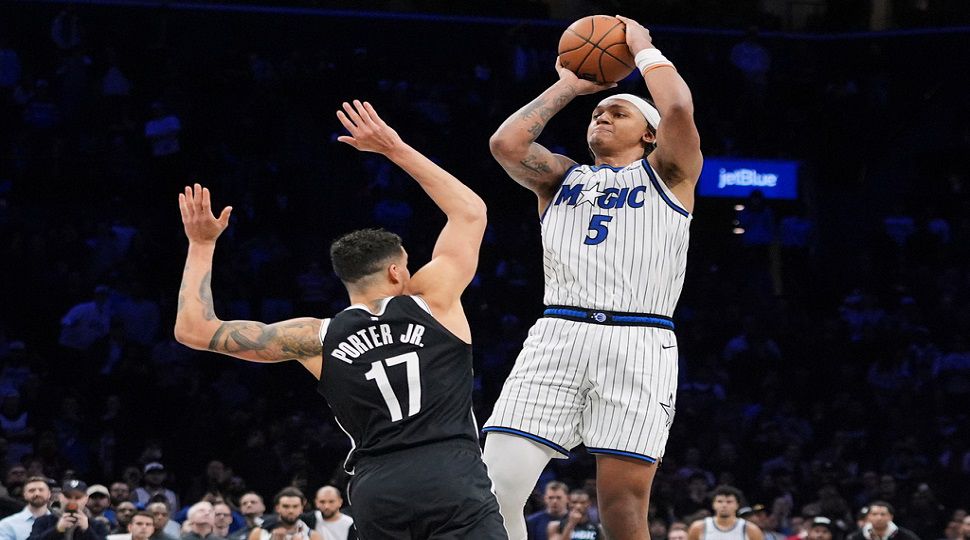 Orlando Magic's Paolo Banchero (5) shoots a game winning three-point shot over Brooklyn Nets' Michael Porter Jr. (17) during the overtime of an NBA basketball game Wednesday, Jan. 7, 2026, in New York. (AP Photo/Frank Franklin II)