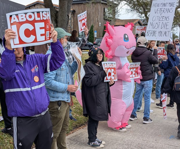 At least one person donned an inflatable costume for the Ice Out of Orlando protest on Saturday, Jan. 31, 2026, near Fashion Square Mall. More than 1,000 people gathered at the intersection of East Colonial Drive and Herndon Avenue. (Brian Bell/Orlando Sentinel)