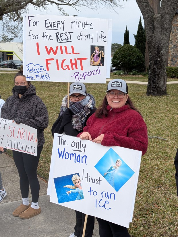 Sisters Caitlyn, left, and Leah, both in their 40s, said the protest Saturday, Jan. 31, 2026, near Fashion Square Mall in Orlando was their first ever. They said they have immigrant friends and don't like that they are living in fear for themselves and their children. (Brian Bell/Orlando Sentinel)