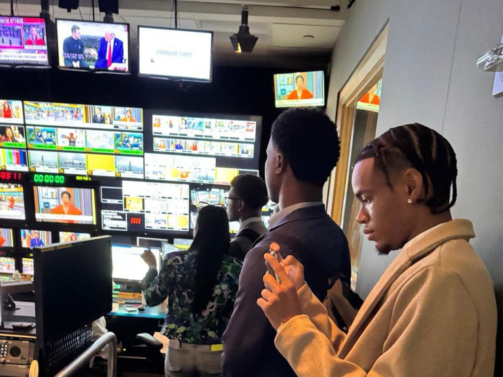 Joel Mitchell captures and manages digital content while working behind the scenes during a live broadcast production.