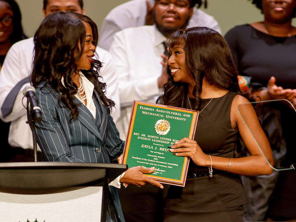 President Marva Johnson presents Zayla Bryant with the MLK Award