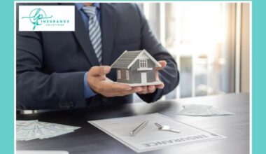 Homeowners Insurance in Cape Coral, FL - LP Insurance Solutions. Professional insurance agent holds a miniature house model, symbolizing the protection and peace of mind Cape Coral homeowners receive. The desk displays insurance documents and house keys,