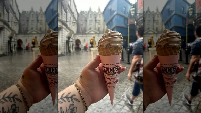 a hand holds a butterbeer ice cream cone