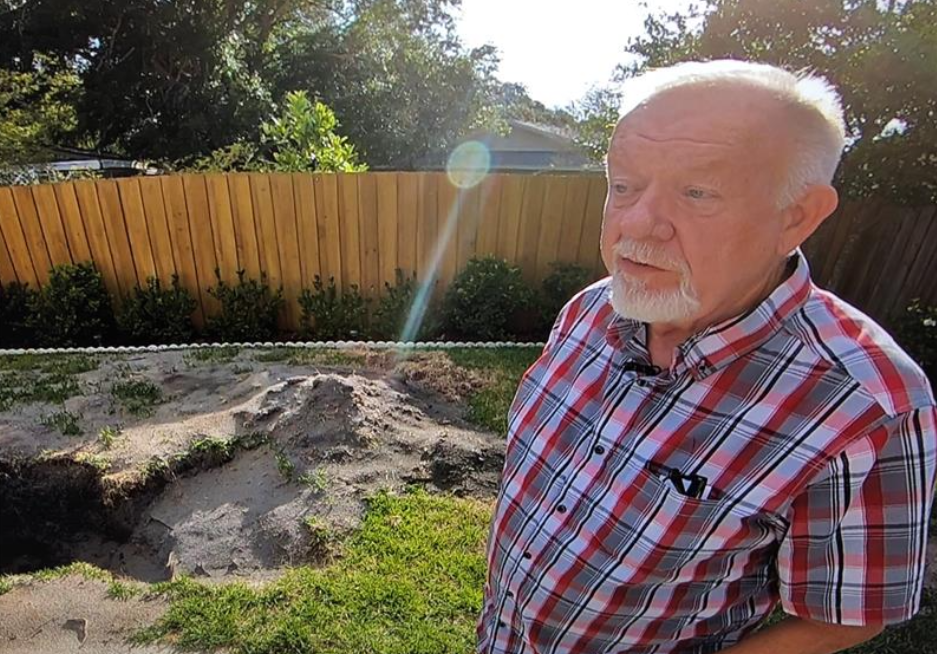 Don Patton stands by hole in his later sister-in-law's backyard where Karen's body was found in May of 202