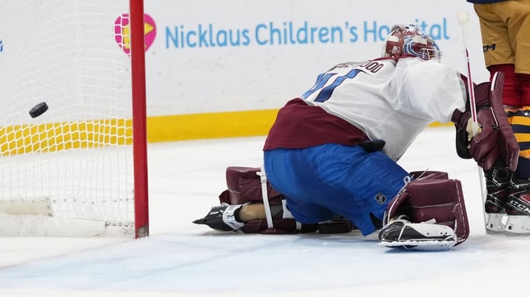 The puck gets past Colorado Avalanche goaltender Scott Wedgewood on...