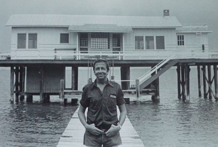 Bob Rauschenberg stands at foot of pier in front of Fish House on his Captiva compound.