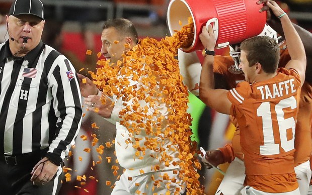 Texas head coach Steve Sarkisian is dunked in Cheez-Its after winning the Cheez-It Citrus Bowl game of Michigan versus Texas at Camping World Stadium in Orlando on Wednesday, December 31, 2025. Texas won the game 41-27. (Stephen M. Dowell/Orlando Sentinel)