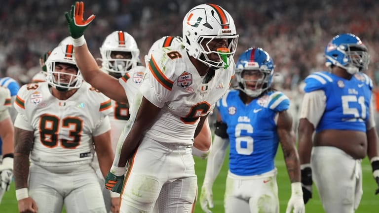 Miami running back Charmar Brown (6) celebrates after scoring a...