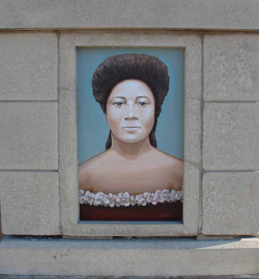 Portrait of Dr. Ella Mae Piper rendered by artist Roland Ruocco on the base of obelisk located on south side of Edwards Ave.
