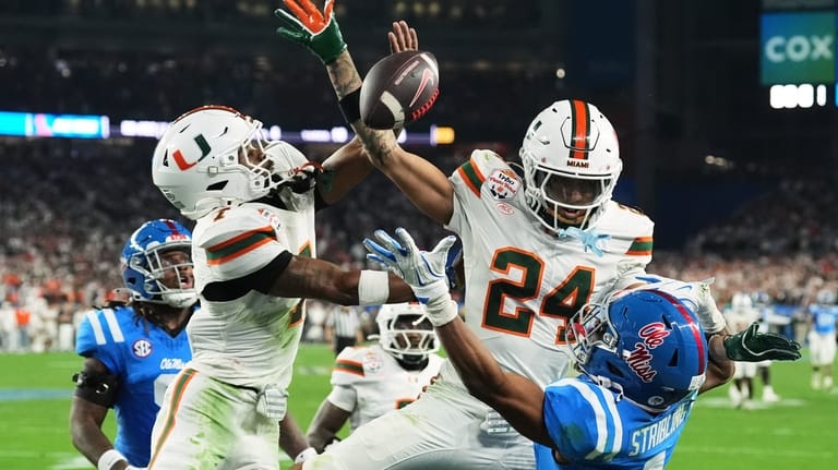 Miami safety Zechariah Poyser (7) and defensive back Ethan O'Connor...