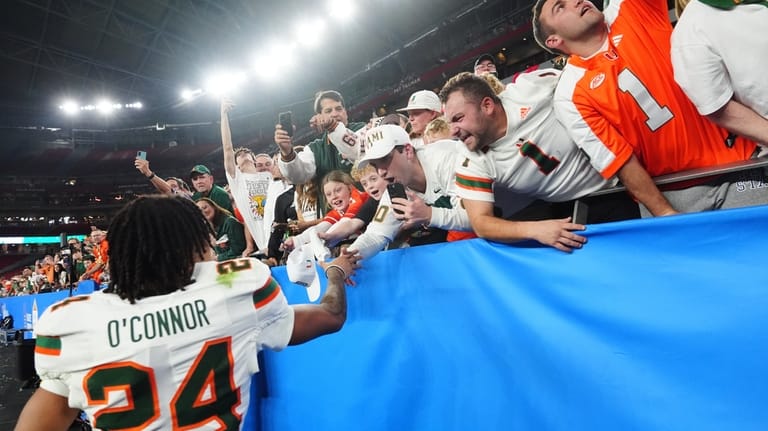 Miami defensive back Ethan O'Connor (24) celebrates with fans after...