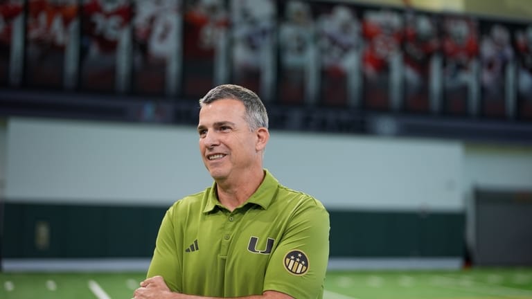 Miami football head coach Mario Cristobal stands on the team's...