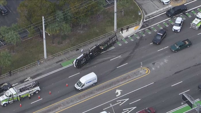 Trailer carrying vehicles rolls over in Davie, causing traffic backups