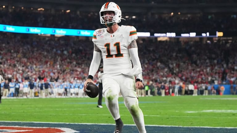 Miami quarterback Carson Beck scores a touchdown during the second...