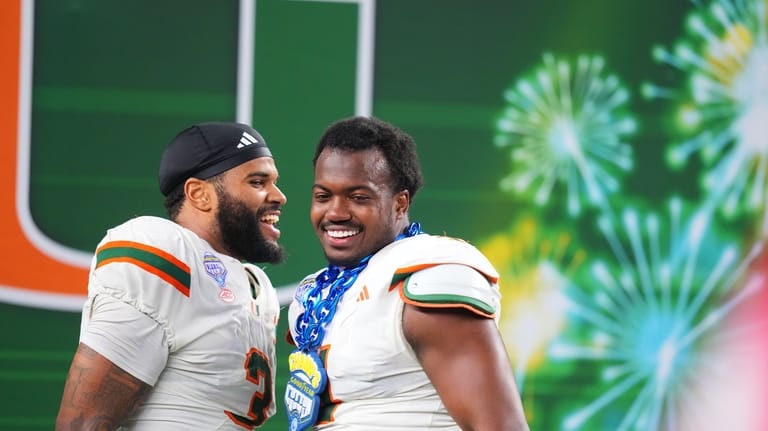 Miami defensive lineman Akheem Mesidor, left, and defensive lineman Rueben...