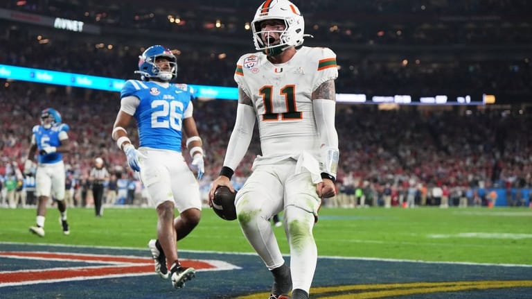 Miami quarterback Carson Beck scores a touchdown during the second...
