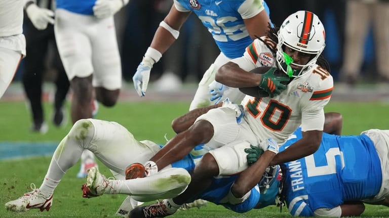 Miami wide receiver Malachi Toney (10) is tackled by Mississippi...