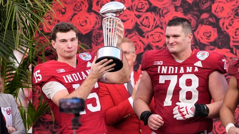 Indiana quarterback Fernando Mendoza (15) and offensive lineman Pat Coogan...