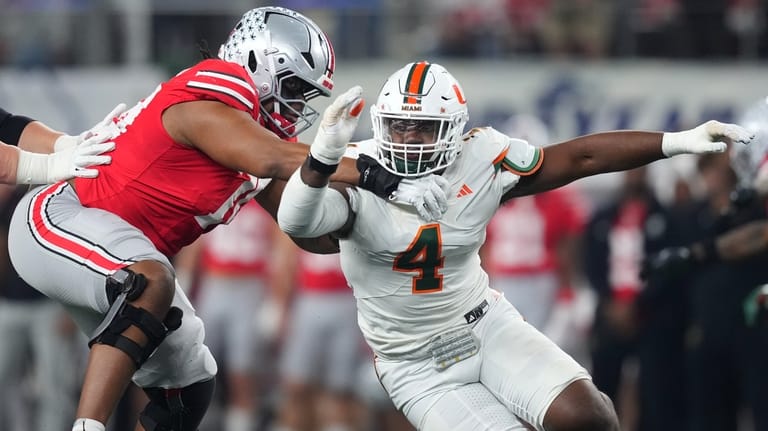 Ohio State offensive lineman Phillip Daniels, left, blocks Miami defensive...