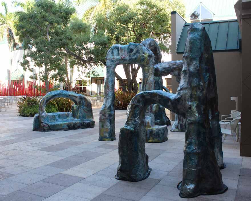 Slumpies in Norris Garden outside the Baker Museum with Dale Chihuly's 'Red Reeds' in background.