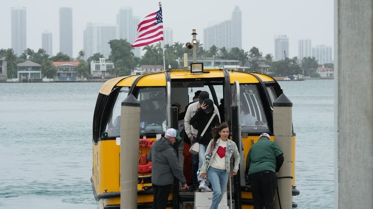 Passengers disembark at the Maurice Gibb Memorial Park, after traveling...
