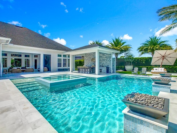 This one-of-a-kind pool includes a central spa that must be accessed by stepping stones. It also has fountains and fire features. (Photo by Tyto Media)