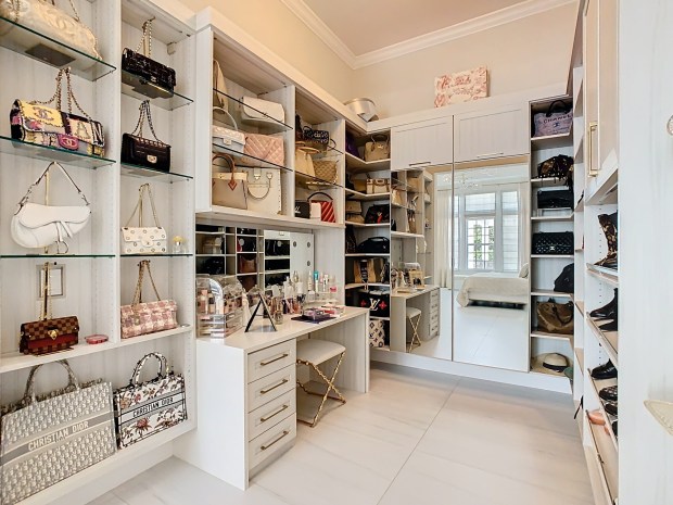The primary suite features two massive walk-in closets, including one designed to show off the owner's handbag collection. (Photo by Tyto Media)