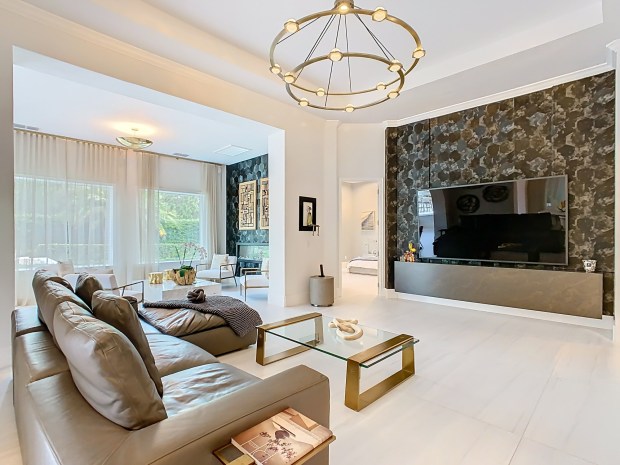 Designer wallpaper and lighting from Restoration Hardware accent the family room and Florida room, which looks out into the backyard. (Photo by Tyto Media)