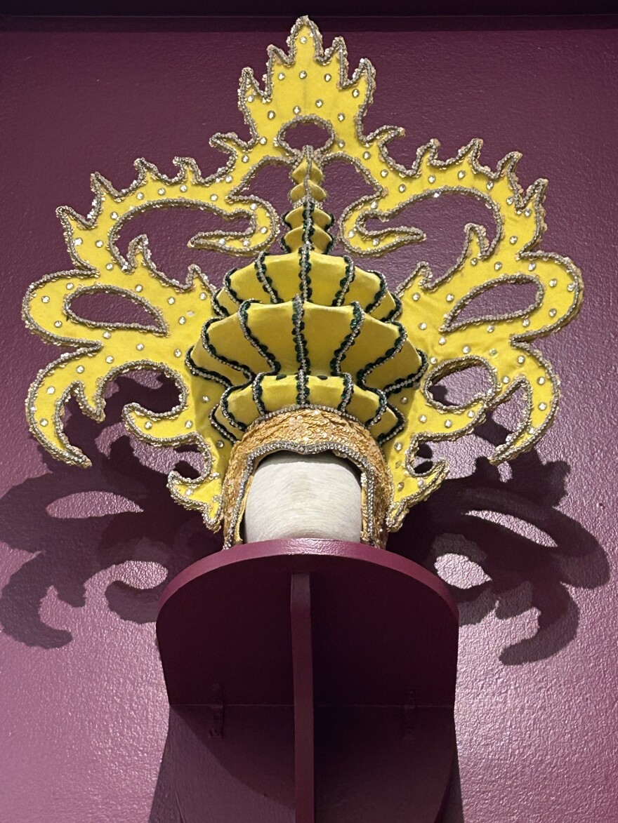 Yellow parade had with purple wall in the background 