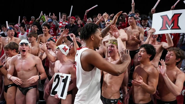 Miami (OH) forward Eian Elmer, center, celebrates with fans following...