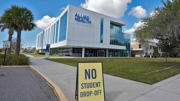 A sign is propped up in front of the Allied...
