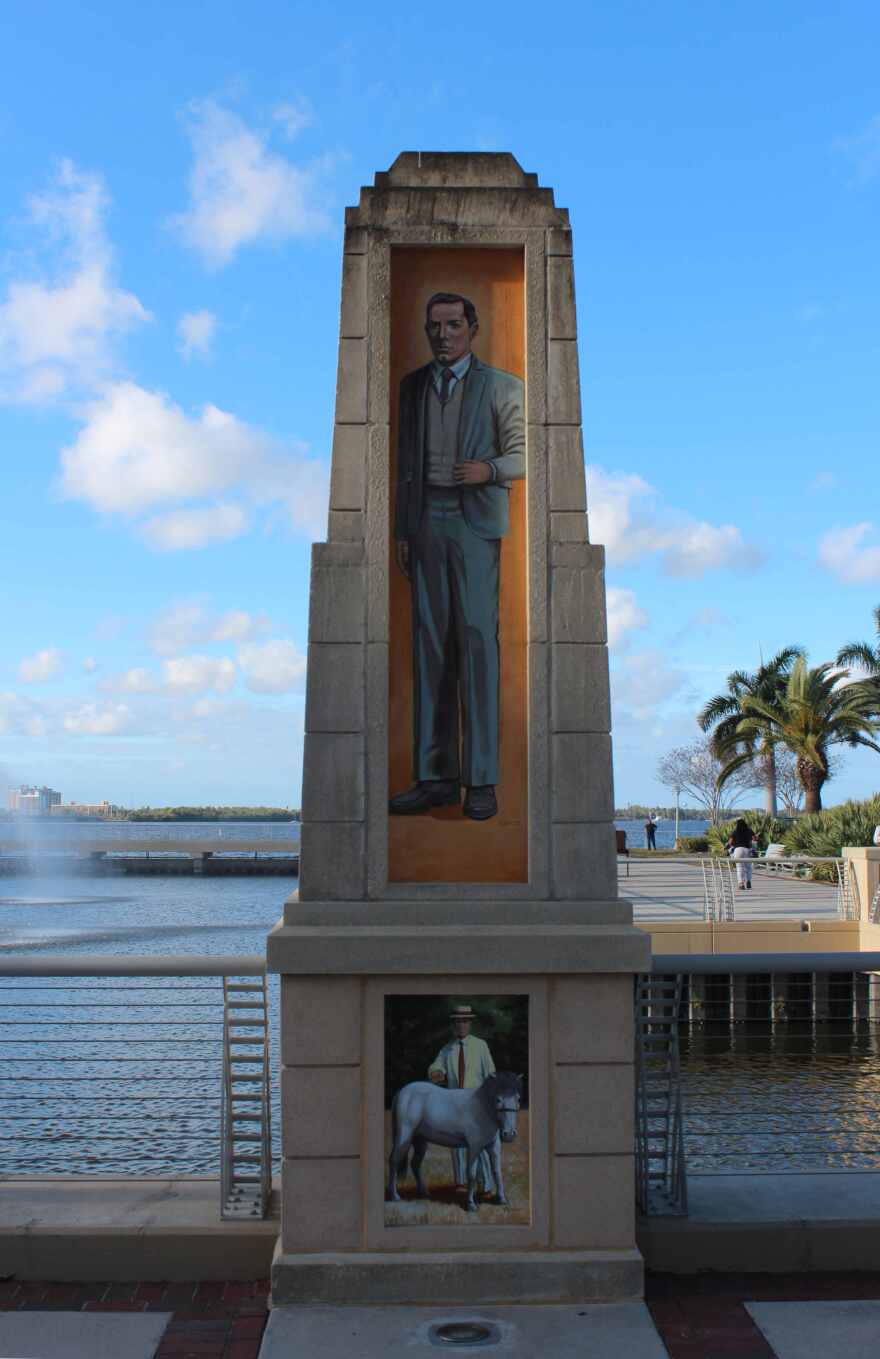 Mural of Harvie Heitman on obelisk on north side of Edwards Ave outside Luminary Hotel.
