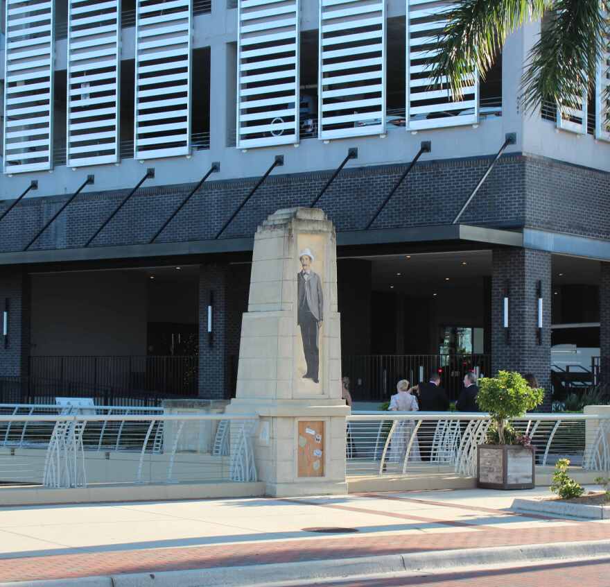 Mural of Manuel A. Gonzalez on obelisk outside entrance to Luminary Hotel