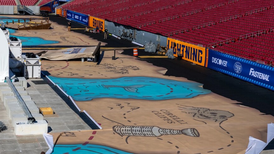 stadium floor has overlay showing what looks like part of a giant treasure map