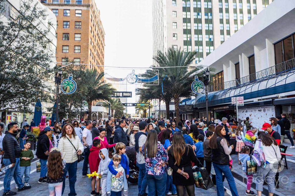 photo of a crowd in winter clothes at a street festival