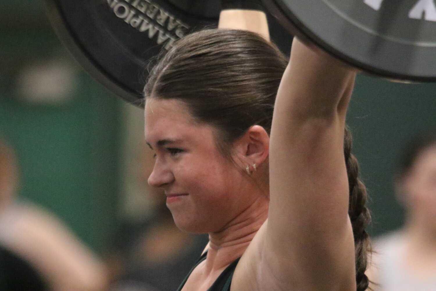 Fleming Island girls weightlifter and state medalist Kathryn Ward smiles for a good lift as she is one of two area lifters that won gold at the prestigious Power of Christmas Weightlifting Invitational at Suwannee High. Fleming Island, the defending Olympics state champion, finished fourth.