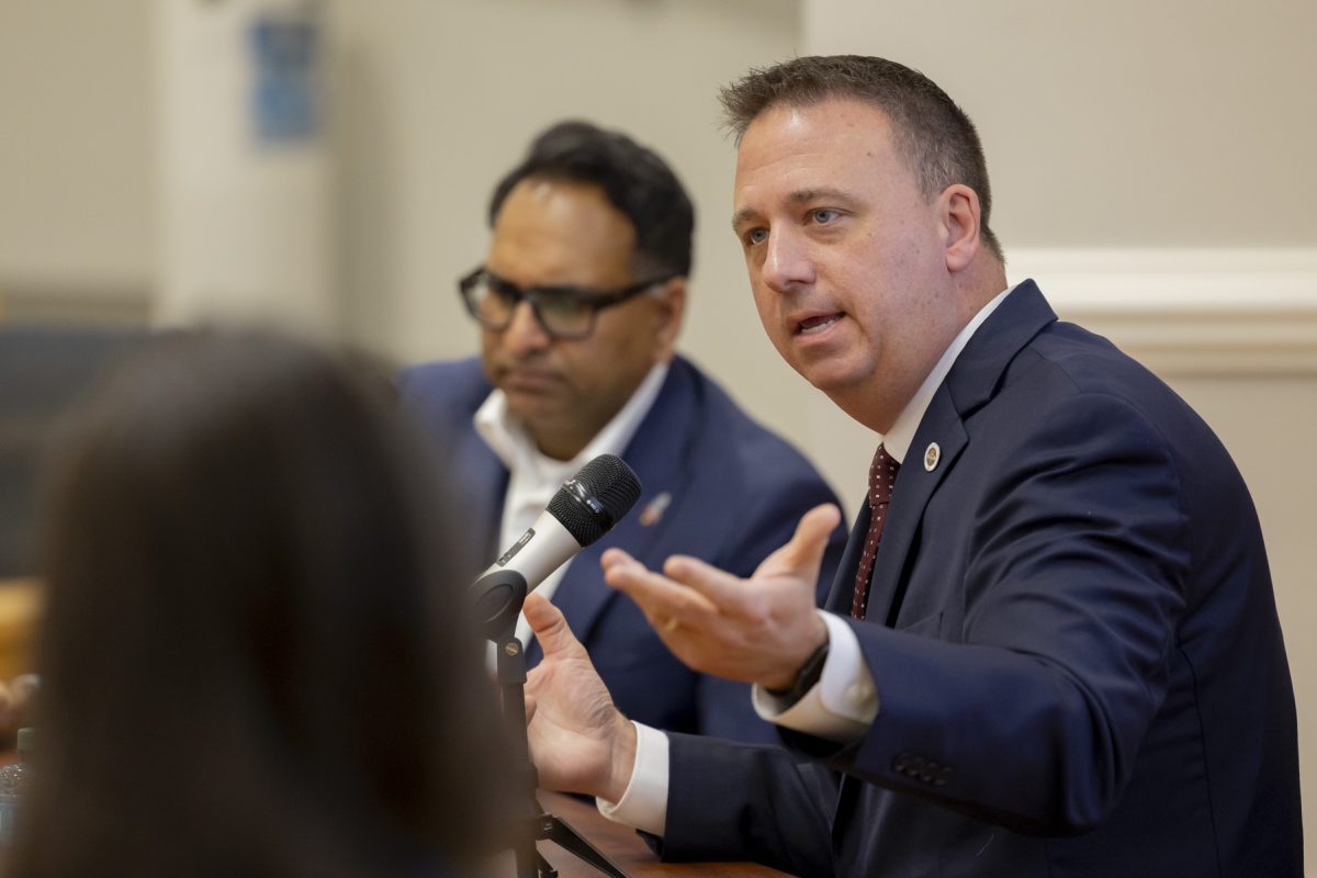 Man speaks with his hands into a microphone