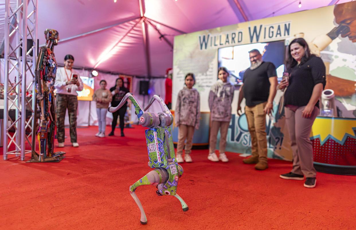 Little Oddy, a robotic dog, performs tricks for guests during the grand opening of Ripley's Believe It or Not! Christmas Park at Amelia Earhart Park on Thursday, Nov. 13, 2025, in Hialeah, Fla.