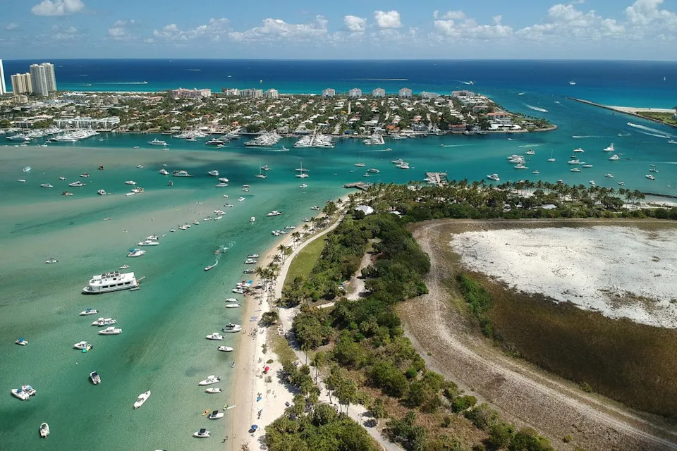 Kevin/Adobe Stock Aerial view of boats off the coast of Peanut Island.