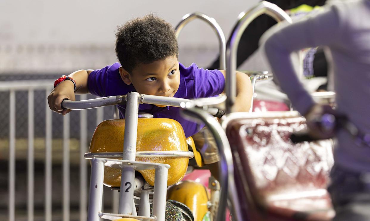 Dane Walker, 4, enjoys a ride during the grand opening of Ripley's Believe It or Not! Christmas Park at Amelia Earhart Park on Thursday, Nov. 13, 2025, in Hialeah, Fla.