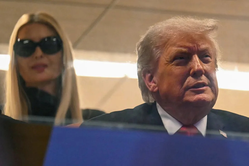 Ivanka looks over her father’s shoulder as the Miami Hurricanes took on the Indiana Hoosiers (AFP via Getty Images)