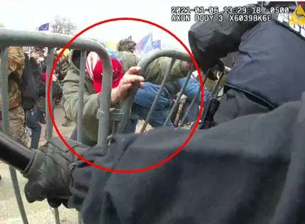 This image of a man struggling to get past a police barrier at the Jan. 6, 2021 U.S. Capitol riot was part of a complaint filed in federal court in Washigton against Garth Nathaniel Walton.