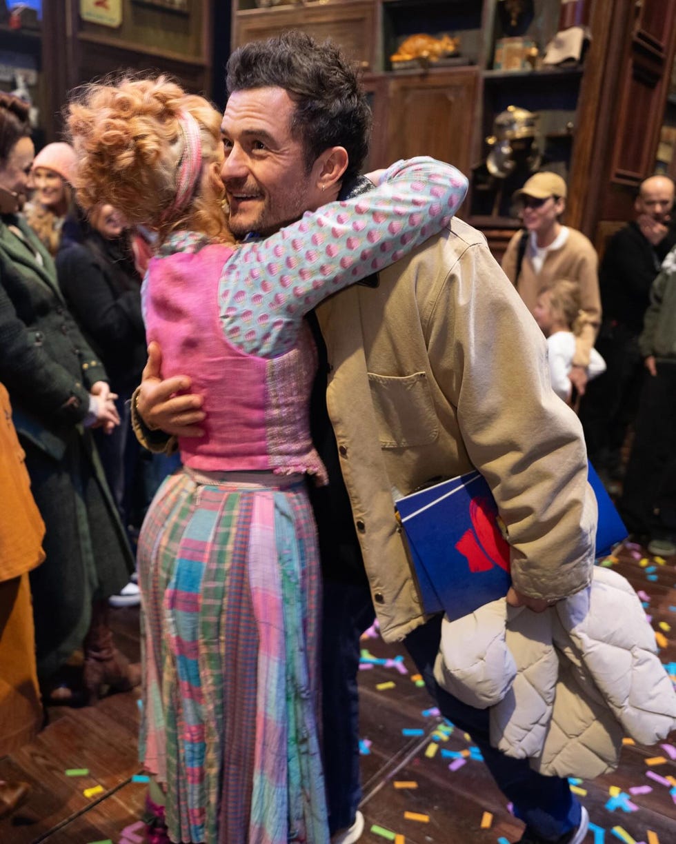 a celebratory embrace between two individuals amidst a lively atmosphere