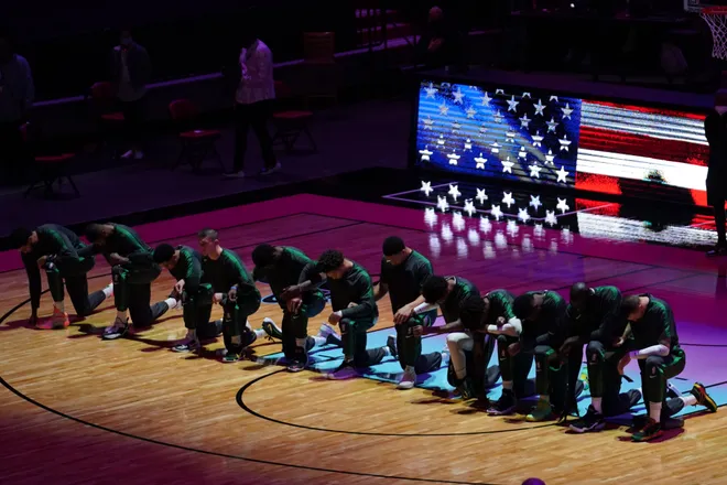 Jan 6, 2021; Miami, Florida, USA; Boston Celtics players kneel during the playing of the national anthem prior to the game against the Miami Heat at American Airlines Arena. Mandatory Credit: Jasen Vinlove-USA TODAY Sports