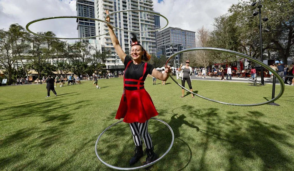 Ali Hoop Mama, with Rainbow Circus, performs at Huizenga Park during the reopening.