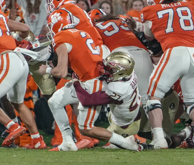 Florida State University defensive back Ashlynd Barker (27) sacks Clemson quarterback Cade Klubnik (2) during the third quarter at Memorial Stadium in Clemson, S.C. Saturday, November 8, 2025.