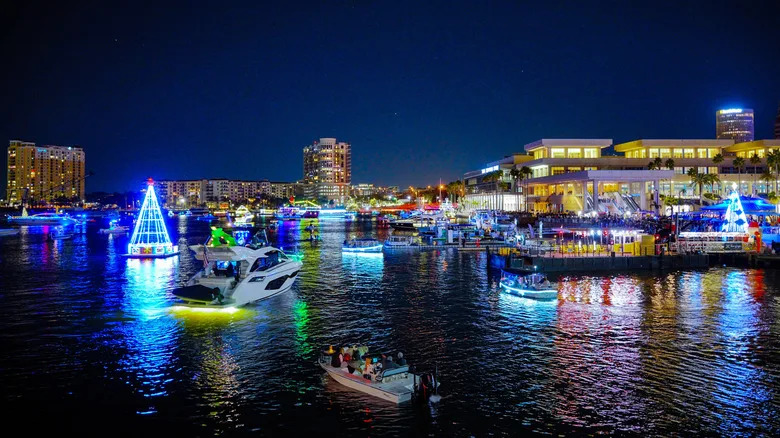 A holiday boat parade passes by Curtis Hixon Waterfront Park in Tampa