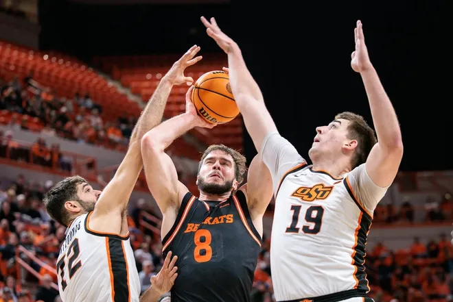 Dec 2, 2025; Stillwater, Oklahoma, USA; Sam Houston Bearkats forward Veljko Ilic (8) shoots the ball around Oklahoma State Cowboys forward Lefteris Mantzoukas (72) and Oklahoma State Cowboys forward Andrija Vukovic (19) during the second half at Gallagher-Iba Arena.